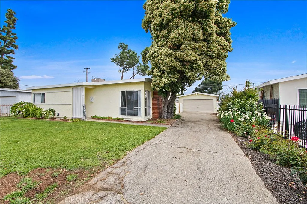 Single-story house real estate with driveway, garage, flowers
