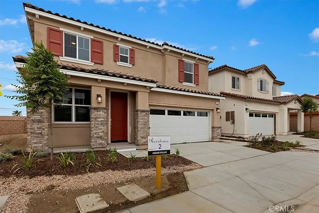 Two-story house real estate with stone accents, red shutters, yard, and Phase 2 sign.