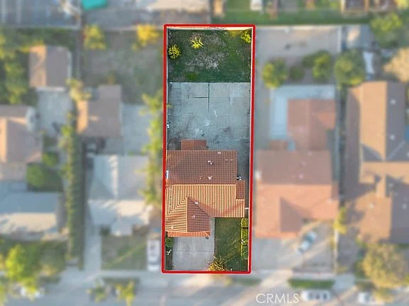 Aerial view of California real estate house and surrounding property outlined in red