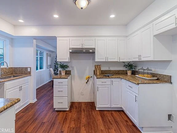 kitchen with white cabinets, granite countertops, and hardwood floor