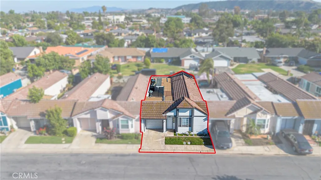 Aerial view of house outlined in red with nearby homes, real estate.