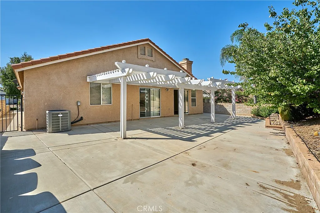 House exterior California real estate with patio, driveway, and plants.
