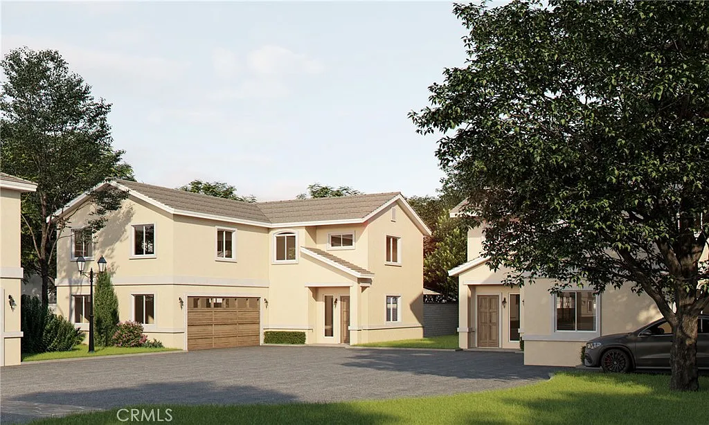 Two houses with a garage, driveway, green grass, and trees, California real estate.