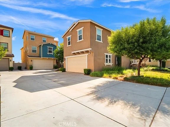 Neighborhood real estate with houses, garages, driveways, and green plants.